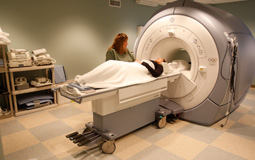 A patient laying down about to into MRI