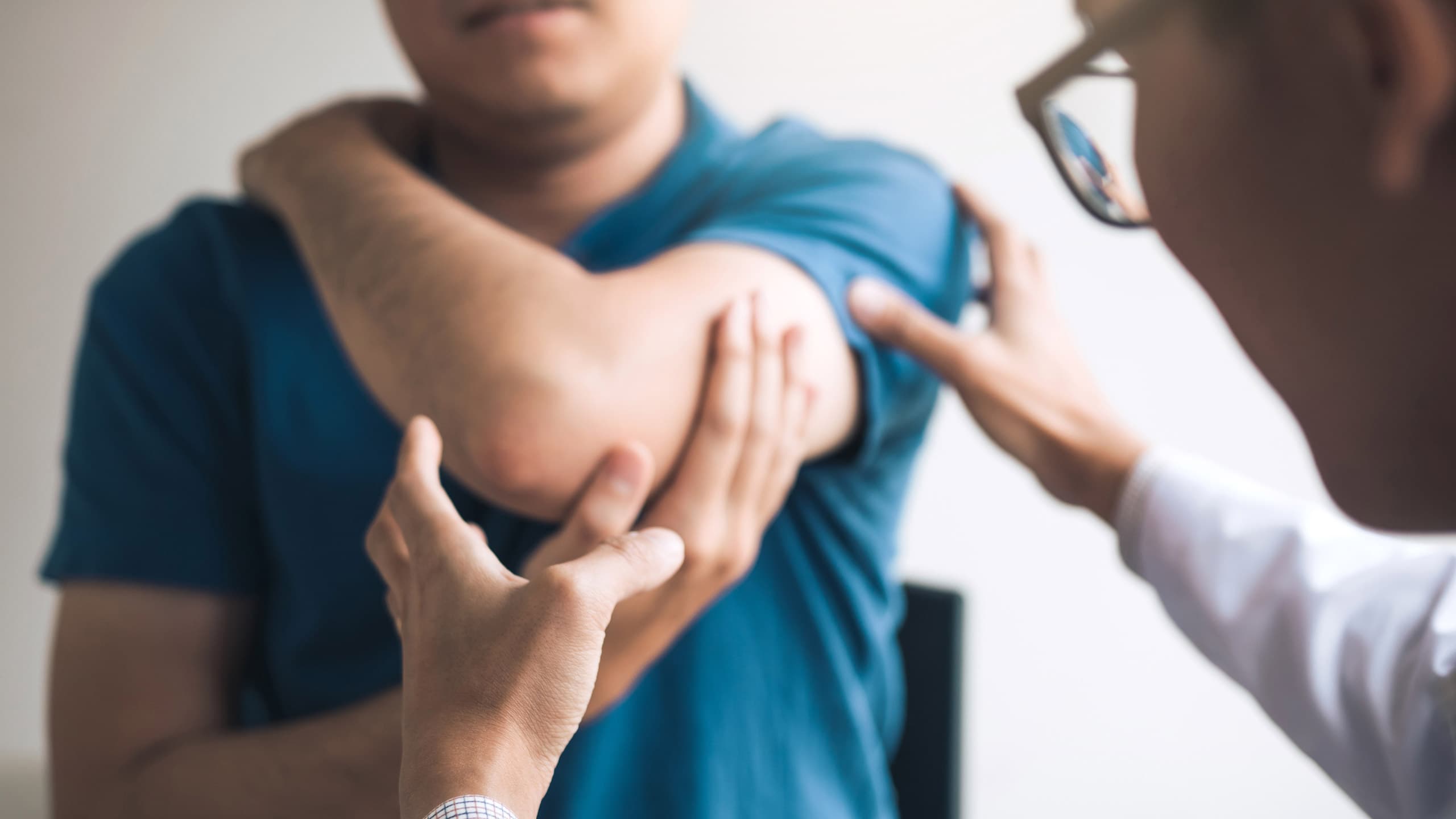 Elbow specialist examining a patient's elbow for elbow pain